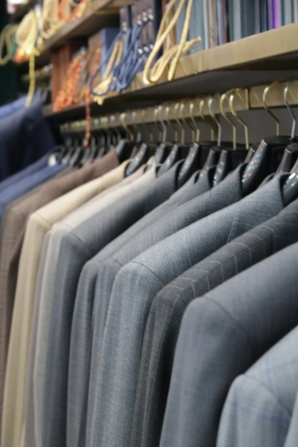 Jackets lined up beneath fabric books inside Wuyue’s shop
